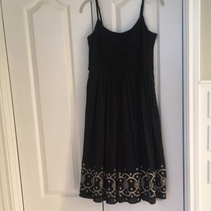 Black cotton dress with tan embroidered hemline.  Tweeds size 4.